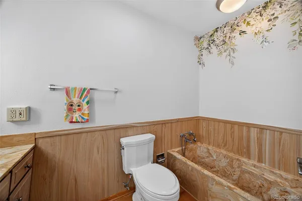 a bathroom with a toilet and a shower curtain