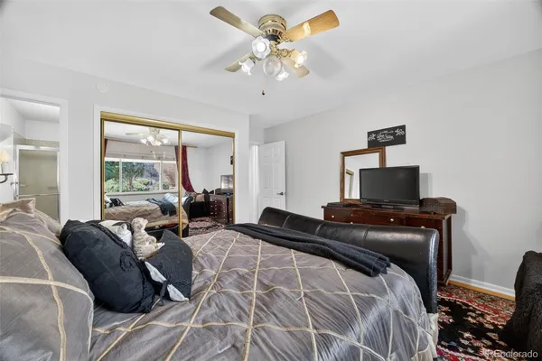 a bedroom with a bed window and couch