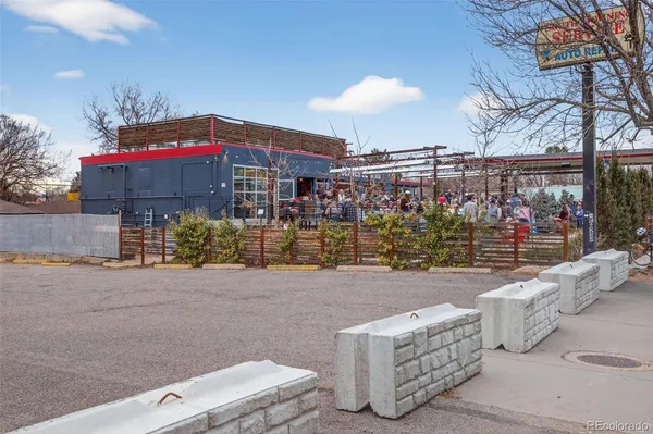 a front view of a building with outdoor seating