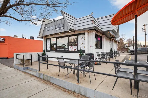 a view of a patio with a table and chairs