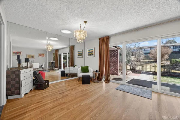 a living room with furniture and a chandelier