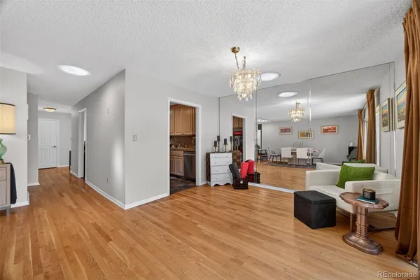 a kitchen view of a refrigerator and a wooden floor