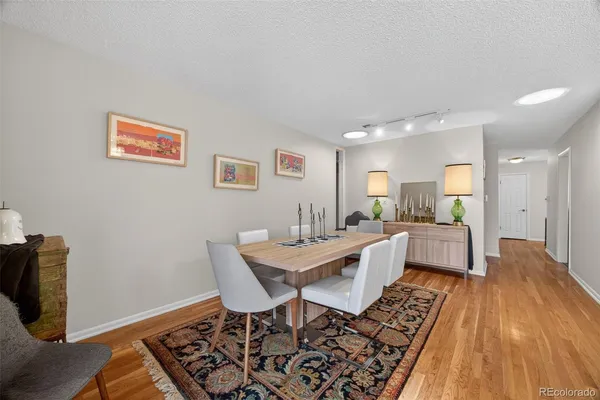 a large living room with stainless steel appliances kitchen island granite countertop furniture and a rug