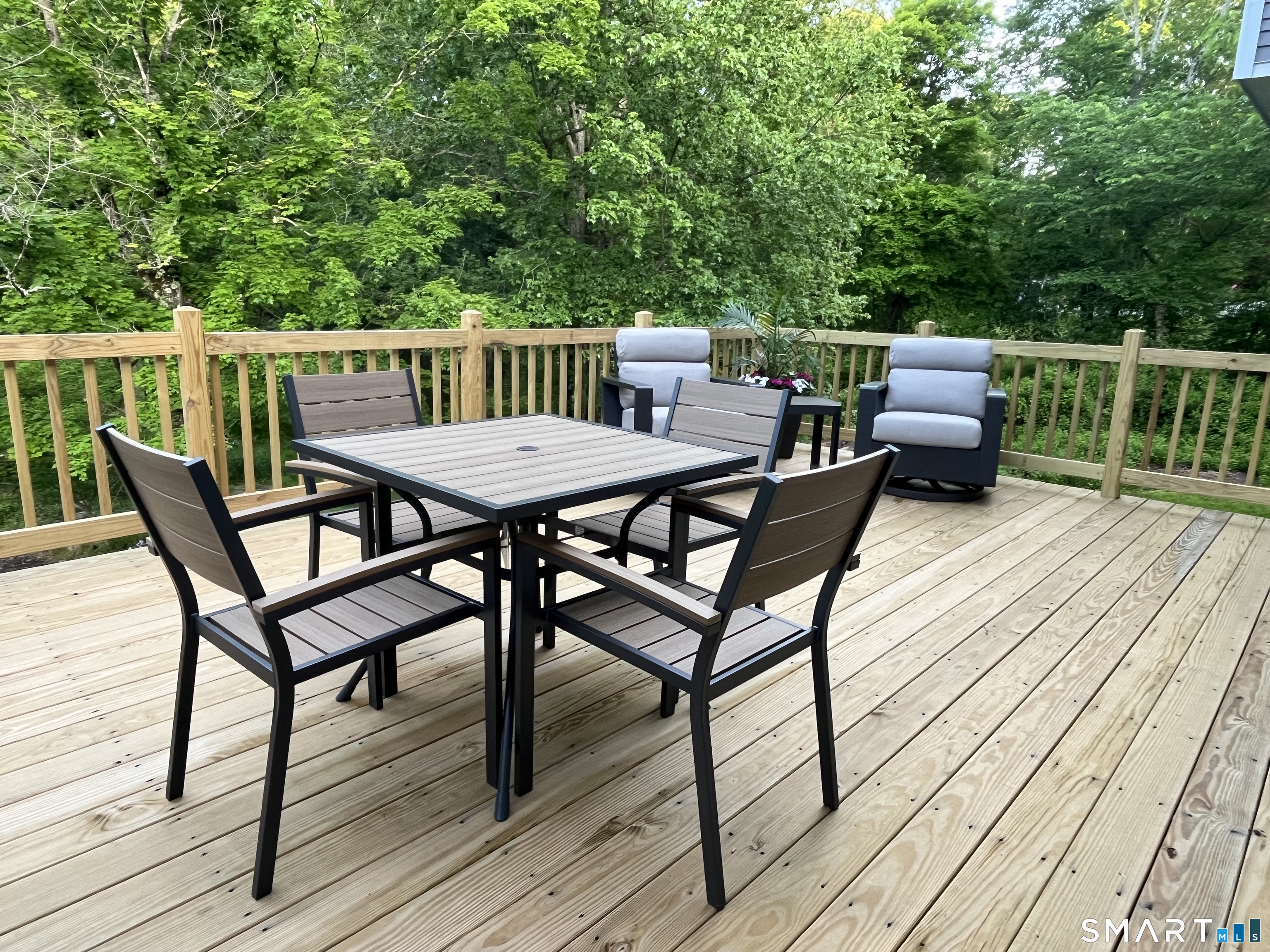 47 Merwin Brook Road Brookfield, CT 06804 - Photo 26 of 29 a view of a dinning table and chairs on deck with wooden floor