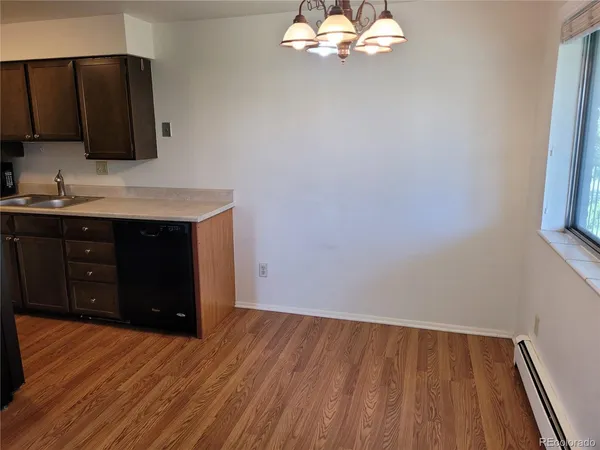 a view of a kitchen with a sink and cabinets