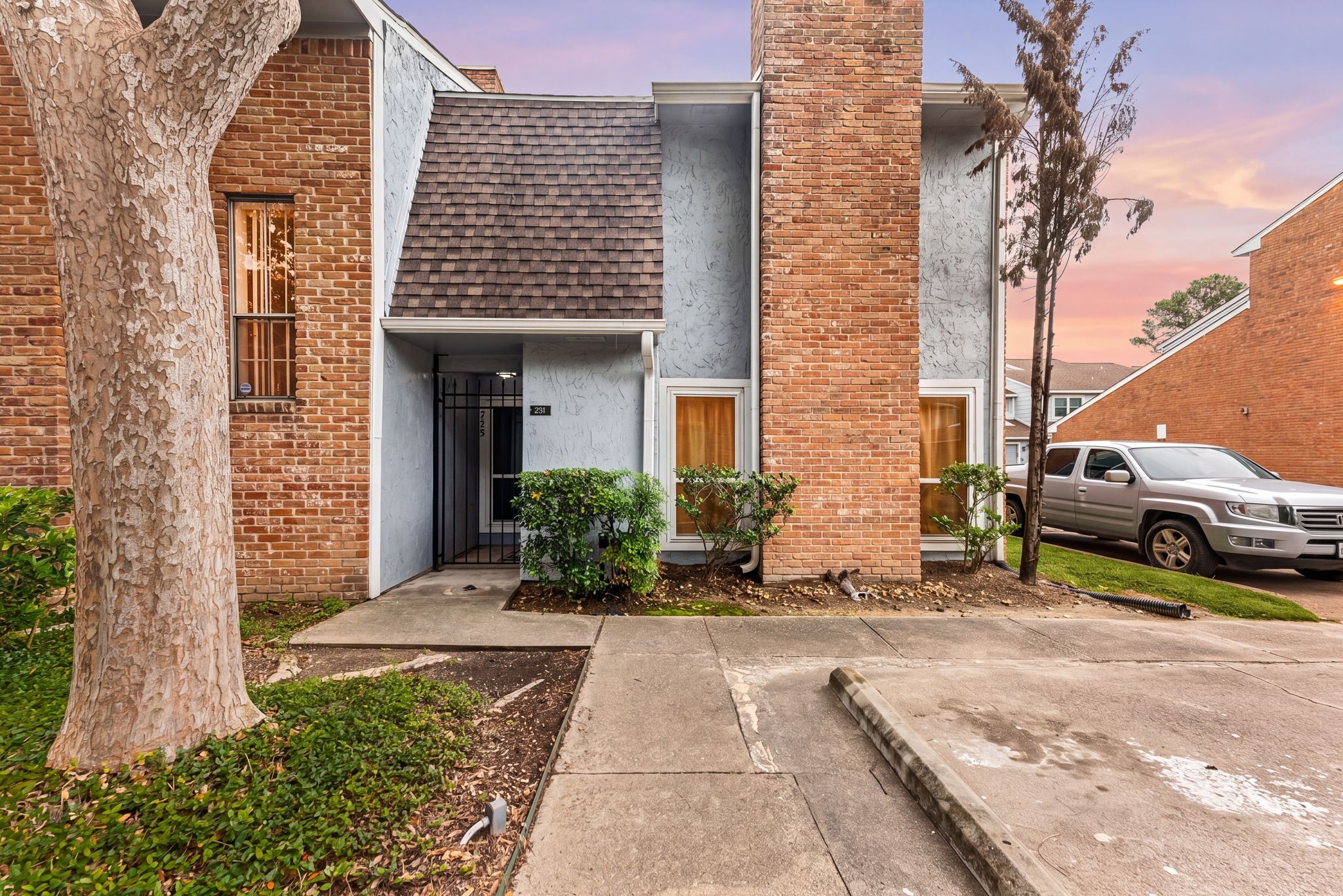 3200 South Gessner Road, Unit 228 Houston, TX 77063 - Photo 1 of 18 Welcome home to 3200 S Gessner Rd #228, a charming brick townhouse featuring a classic elevation, cozy covered entry, and lush greenery, all glowing beautifully under a stunning Houston twilight sky. Conveniently located in the heart of Westchase with easy access to major highways, shopping, and dining, this one is a must-see!