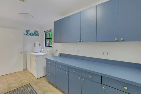 a kitchen with a sink cabinets and a stove top oven