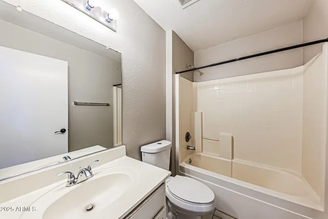 an empty room with a chandelier fan and a chandelier fan