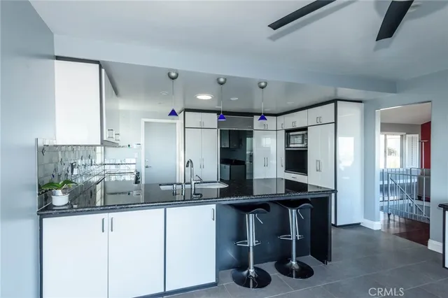 a kitchen with stainless steel appliances kitchen island granite countertop a sink and cabinets