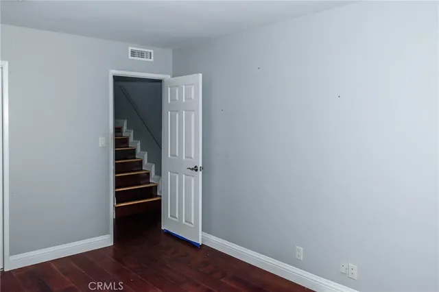 a view of entryway with stairs and wooden floor