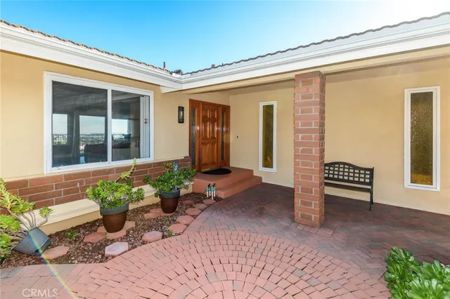 a front view of a house with a large window and chair