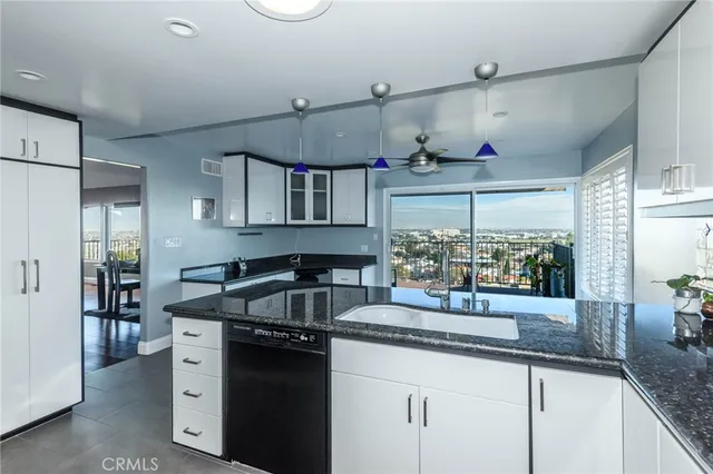 a kitchen with granite countertop a sink stainless steel appliances and cabinets