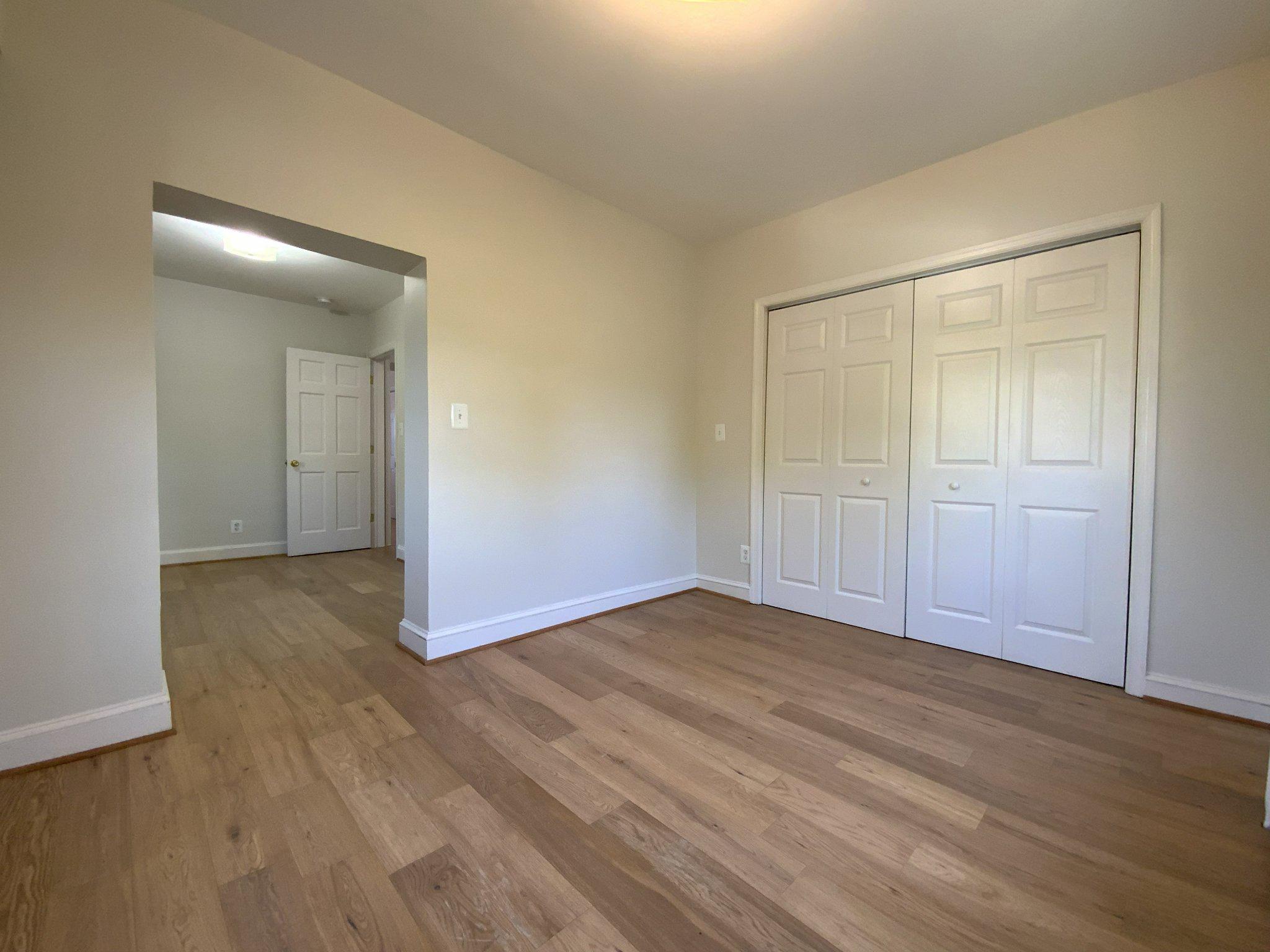 1772 E Street Northeast Washington, DC 20002 - Photo 13 of 23 a view of an empty room with wooden floor