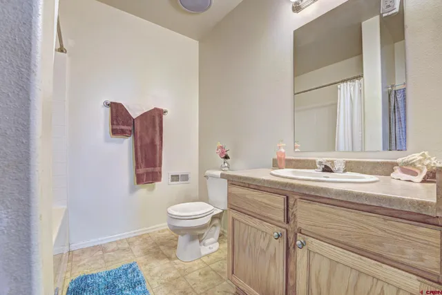 a bathroom with a toilet a sink and a mirror