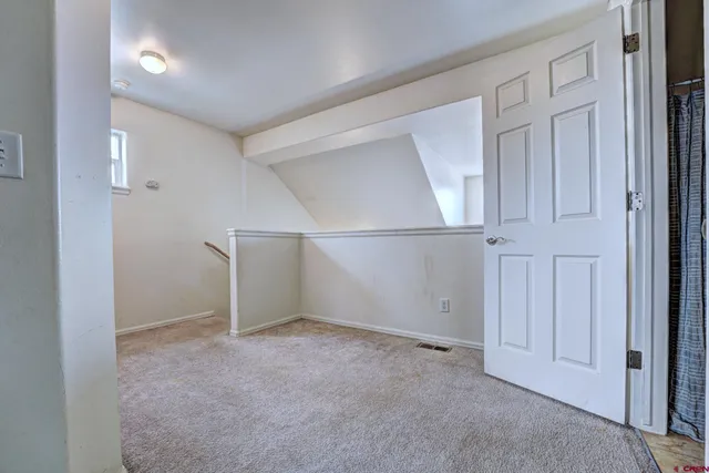 a view of a workspace with furniture and a workspace