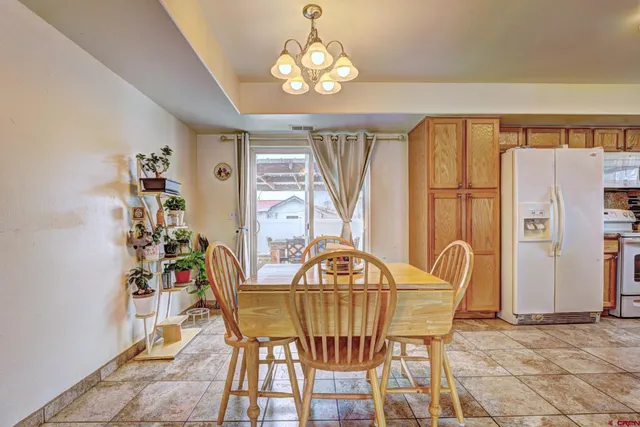 a view of a dining room with furniture and chandelier