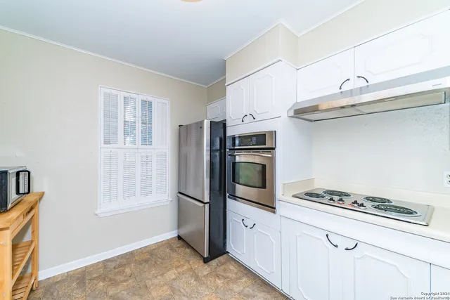 a kitchen with stainless steel appliances a stove a microwave and a refrigerator