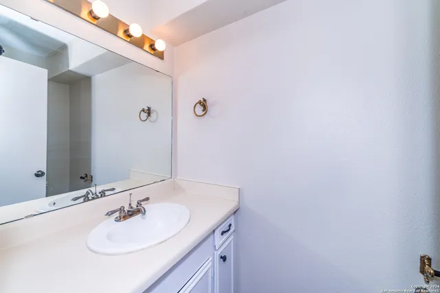 a bathroom with a sink and a mirror