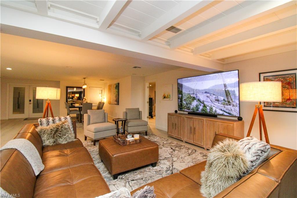 1555 Crayton Road Naples, FL 34102 - Photo 12 of 50 Tiled living room featuring beam ceiling