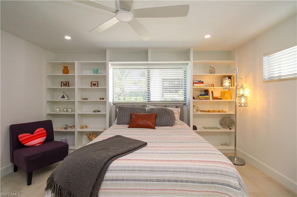 1555 Crayton Road Naples, FL 34102 - Photo 15 of 50 Bedroom with ceiling fan, light wood-type flooring, and multiple windows
