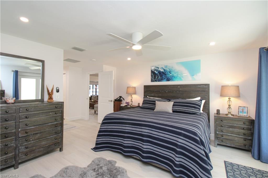 1555 Crayton Road Naples, FL 34102 - Photo 20 of 50 Bedroom featuring ceiling fan and light wood-type flooring