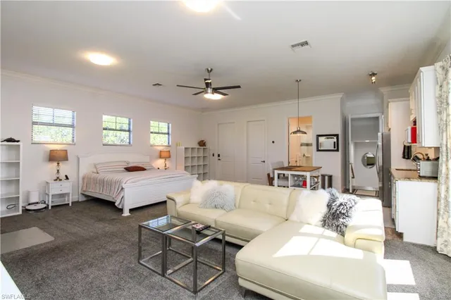 a living room with furniture and white walls