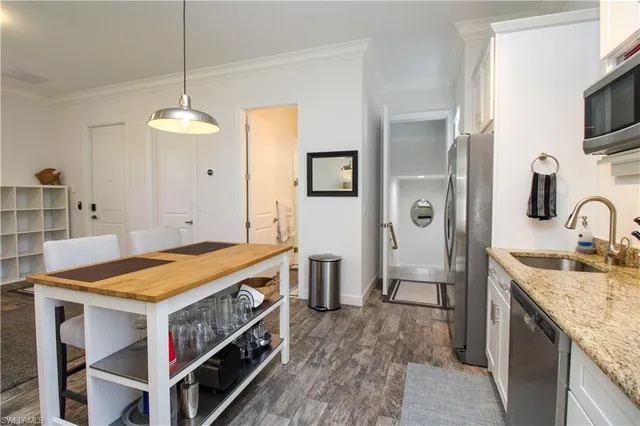 a open kitchen with stainless steel appliances granite countertop a stove and refrigerator