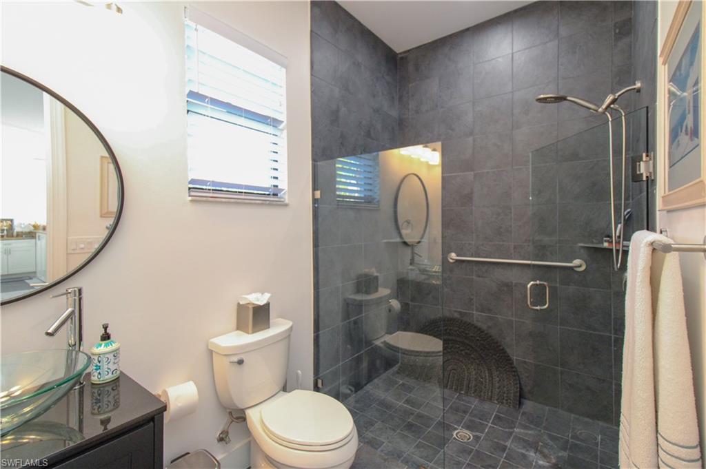 1555 Crayton Road Naples, FL 34102 - Photo 31 of 50 Bathroom featuring an enclosed shower, vanity, and toilet