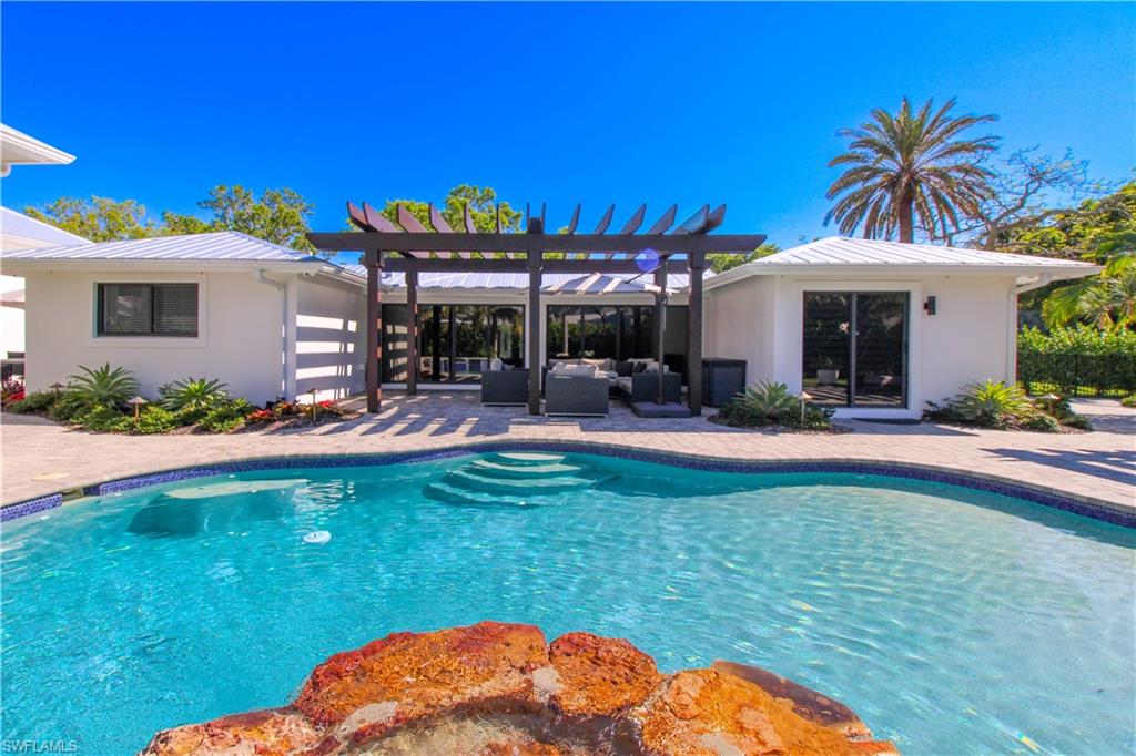 1555 Crayton Road Naples, FL 34102 - Photo 34 of 50 View of pool with a pergola, an outdoor living space, and a patio