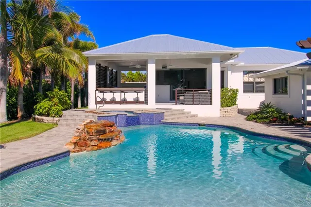 a view of a house with backyard porch and sitting area