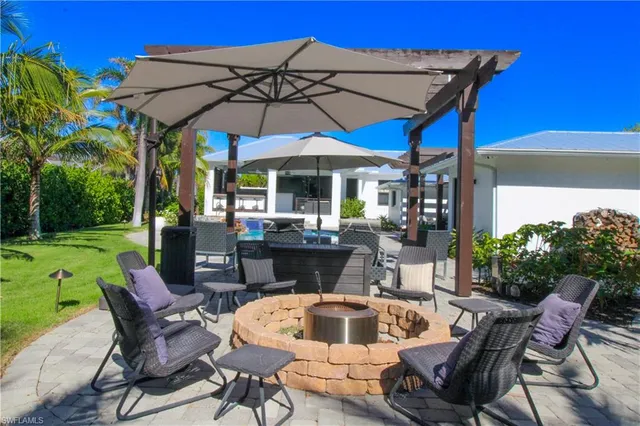 a view of an outdoor sitting area with furniture and umbrella