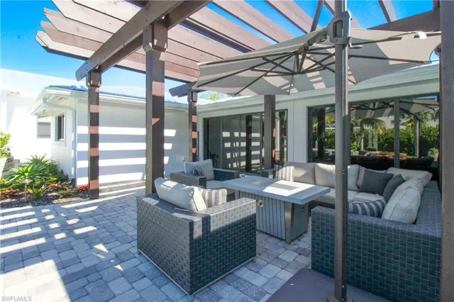 a view of a patio with couches and potted plants