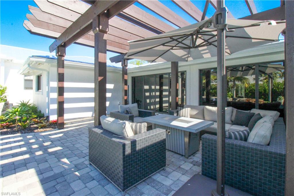 1555 Crayton Road Naples, FL 34102 - Photo 41 of 50 View of patio featuring a pergola and an outdoor living space with a fire pit