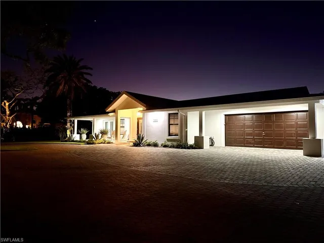 a yellow house with yard in front of it