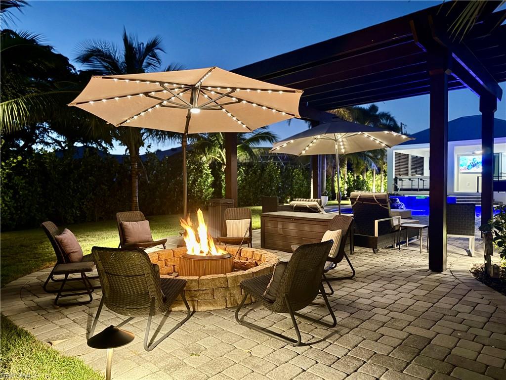 1555 Crayton Road Naples, FL 34102 - Photo 44 of 50 View of patio featuring an outdoor living space with a fire pit