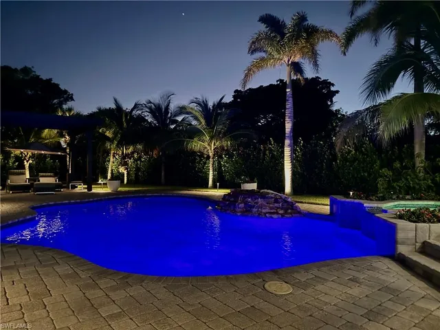 a view of swimming pool with outdoor seating