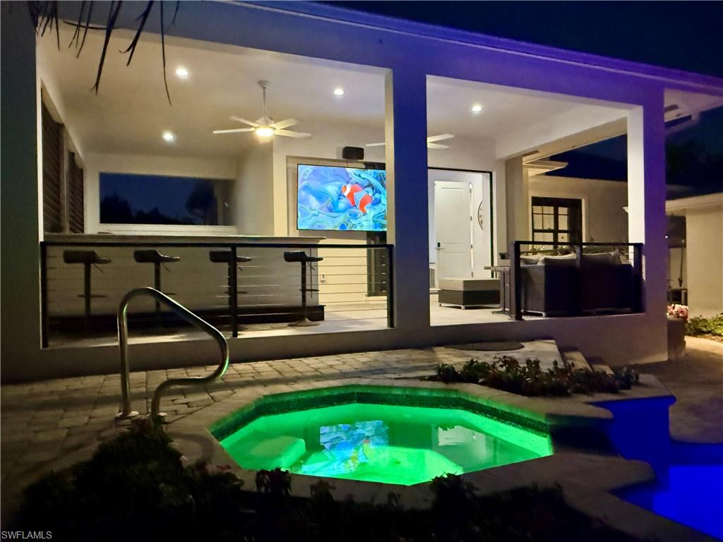 1555 Crayton Road Naples, FL 34102 - Photo 49 of 50 Pool at night with a patio area and ceiling fan