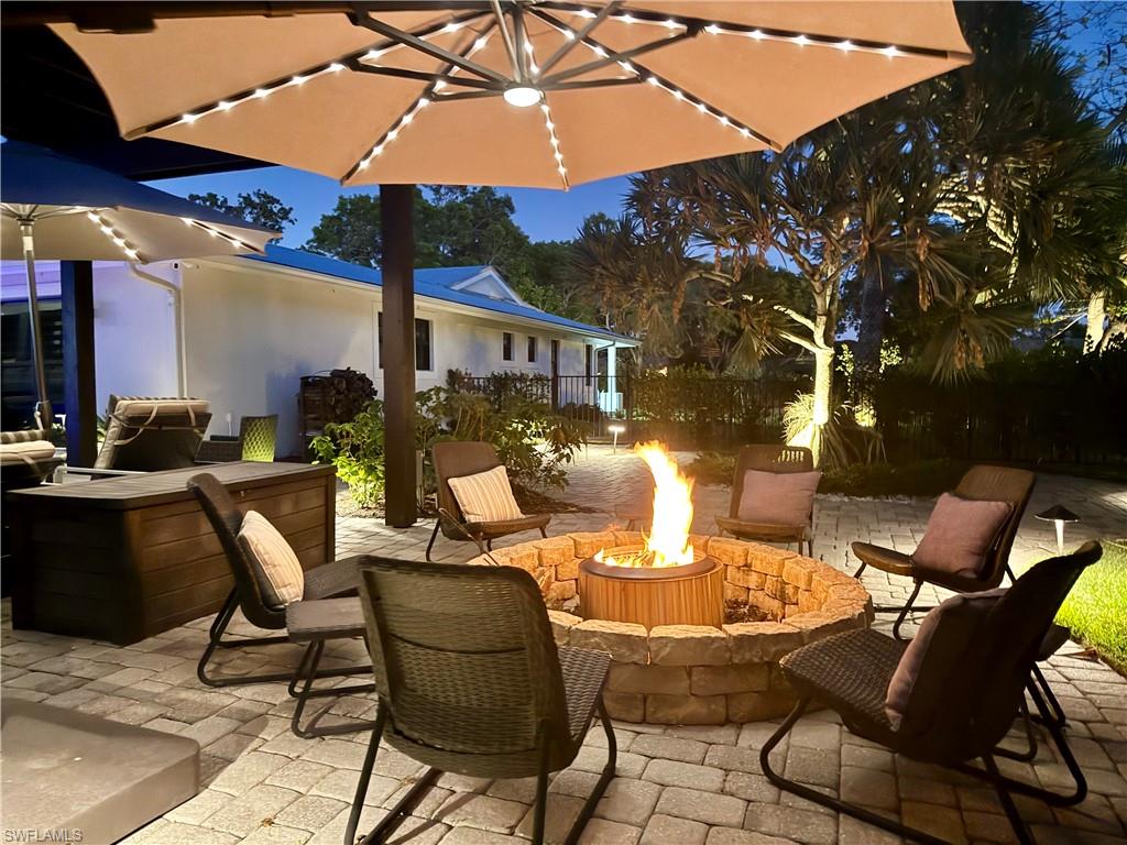 1555 Crayton Road Naples, FL 34102 - Photo 50 of 50 View of patio featuring an outdoor fire pit