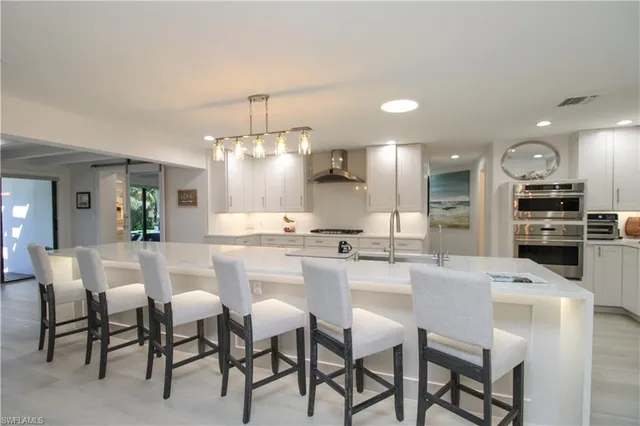 a large kitchen with a table and chairs