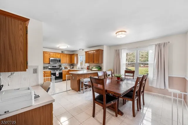 a view of a dining room with furniture and a window