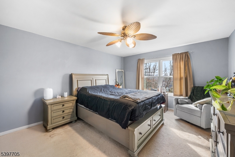 50 Blau Road Hackettstown, NJ 07840 - Photo 20 of 35 a bedroom with a bed and a chandelier