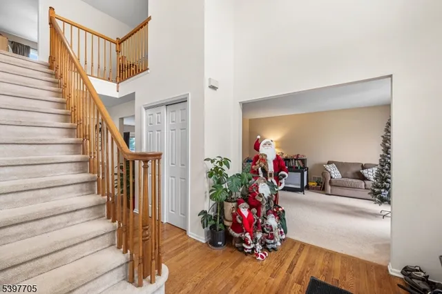 a view of a livingroom with furniture entryway wooden floor and front door
