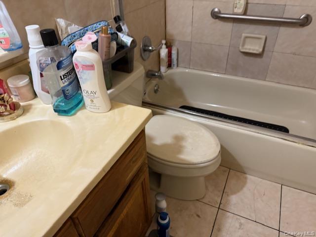 2120 Clinton Avenue Bronx, NY 10457 - Photo 11 of 21 a bathroom with a sink a toilet and mirror