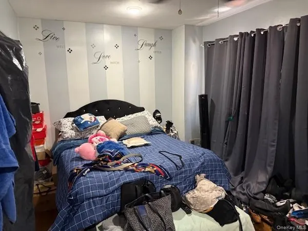 a bedroom with a bed and a wooden floor