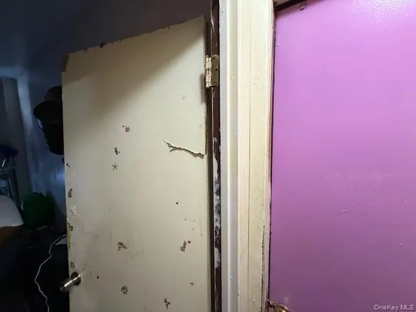 a bed sitting in a bedroom next to a lamp