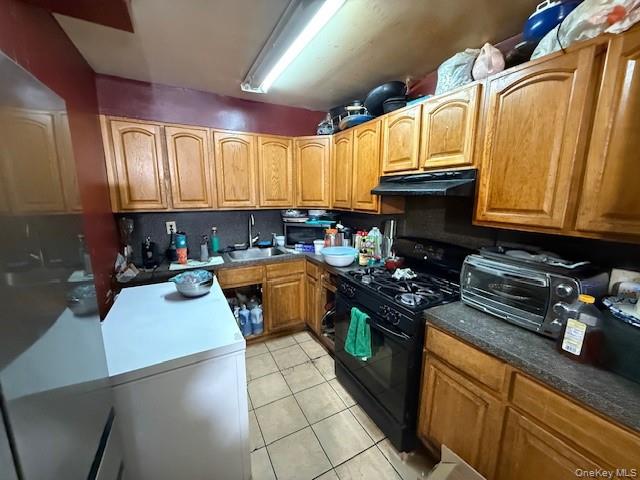 2120 Clinton Avenue Bronx, NY 10457 - Photo 5 of 21 a kitchen with stainless steel appliances granite countertop a stove a sink a microwave and cabinets