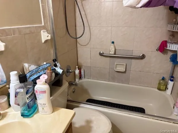a bathroom with a sink a toilet and mirror