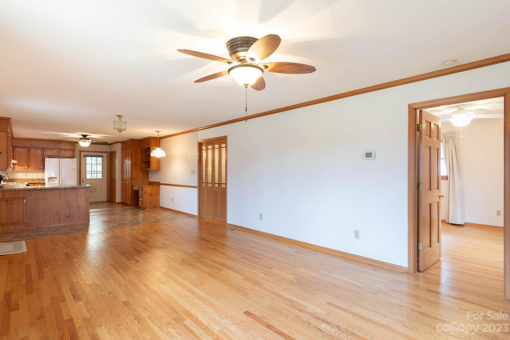 7869 Cherry Point Drive Denver, NC 28037 - Photo 12 of 38 a view of an empty room with wooden floor and a window