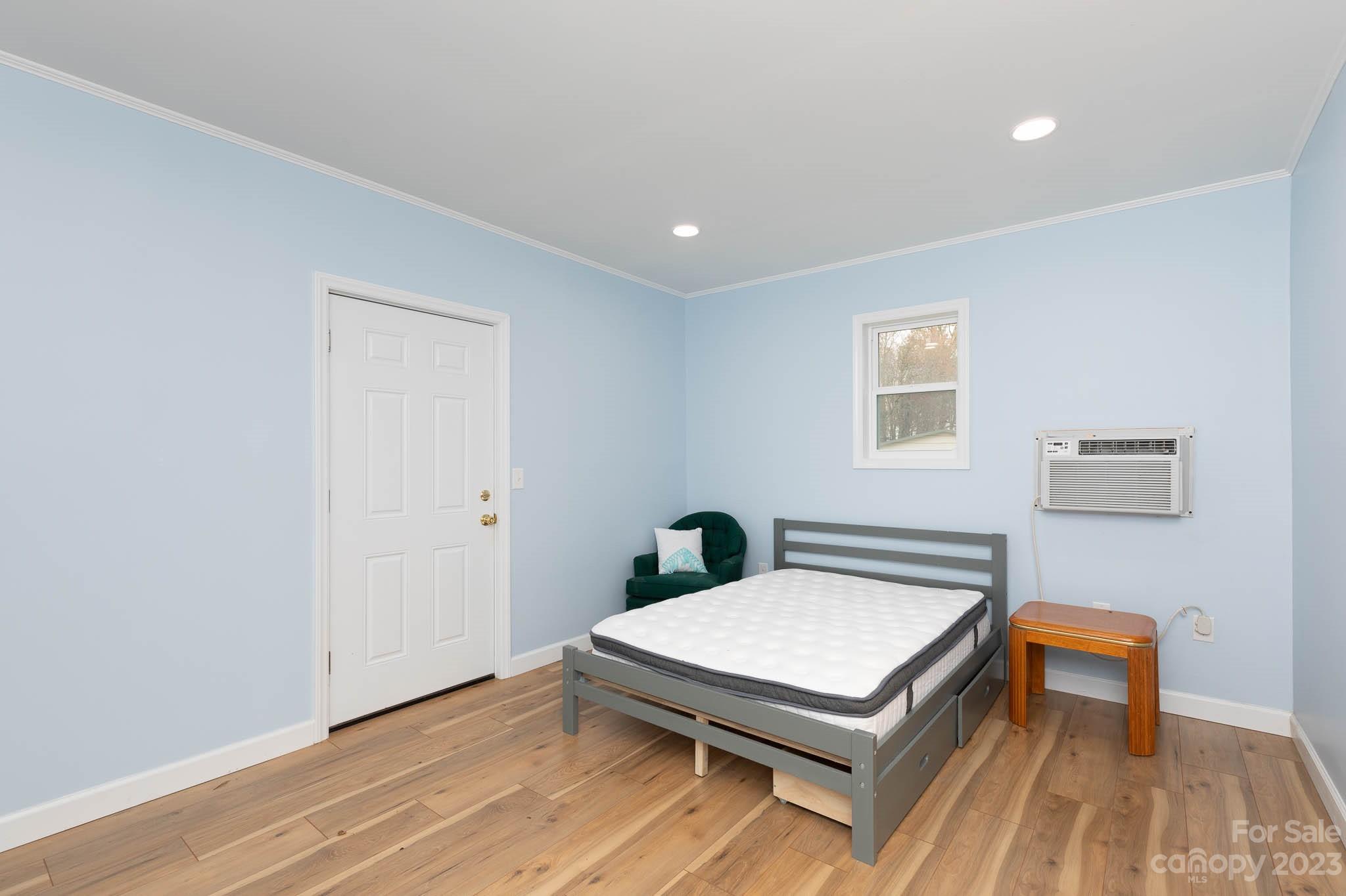 7869 Cherry Point Drive Denver, NC 28037 - Photo 18 of 38 a living room with a bed and a table