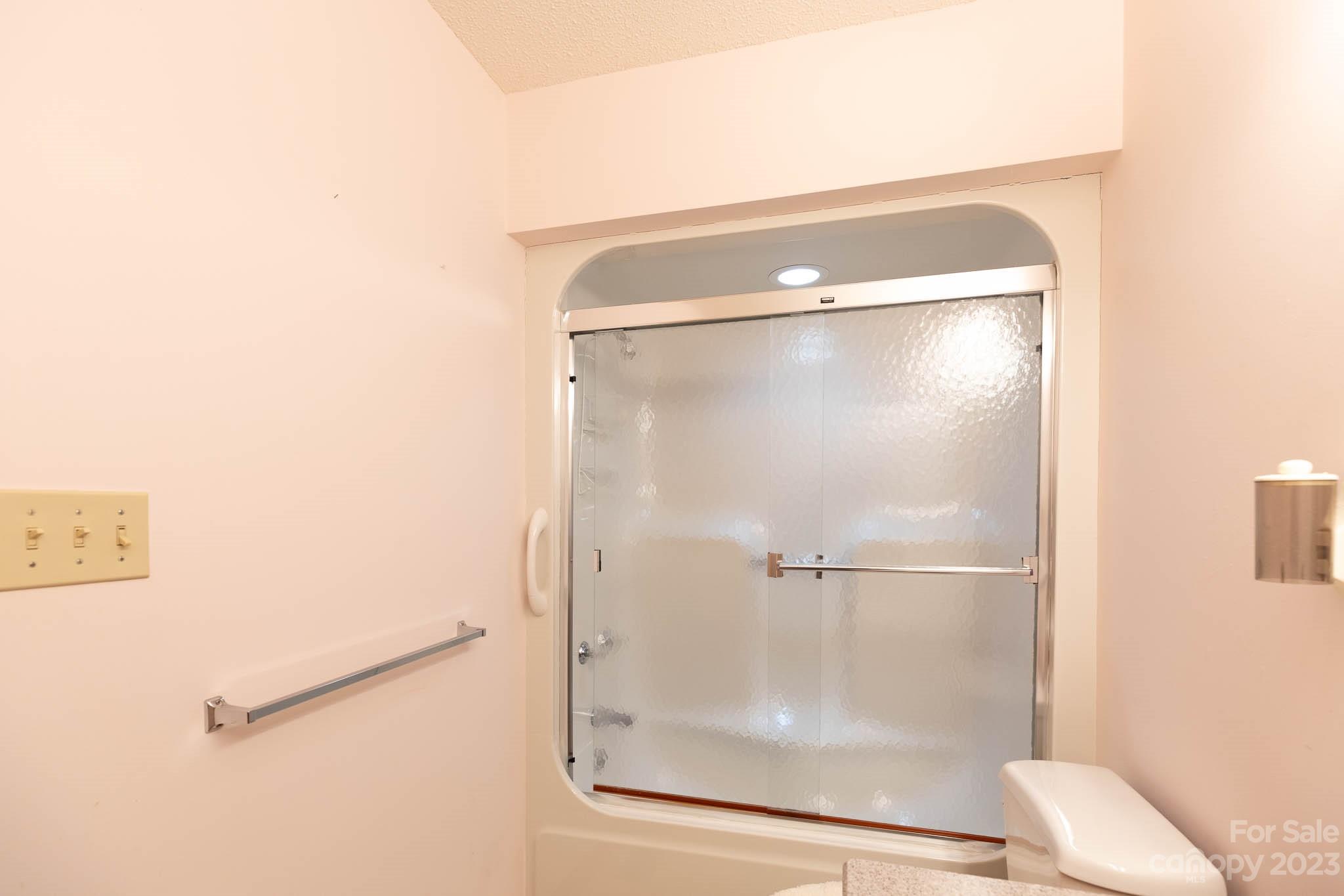 7869 Cherry Point Drive Denver, NC 28037 - Photo 22 of 38 a bathroom with a glass shower door